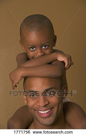 Stock Photograph - Son on father's shoulders. Fotosearch