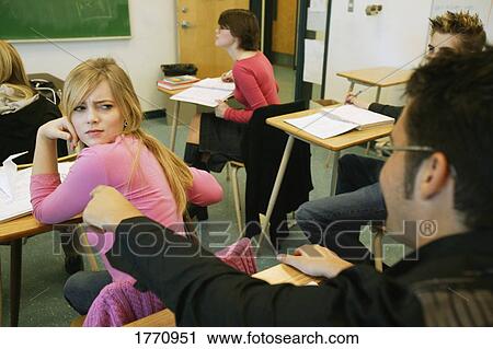 Stock Image - Student bugging another student. Fotosearch
