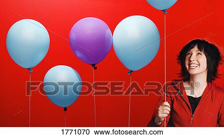 Stock Image - Teenage girl with balloons. Fotosearch
