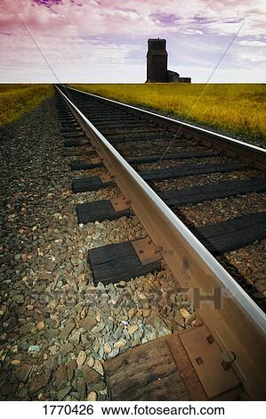 Stock Photograph - Train track with grain elevator. Fotosearch