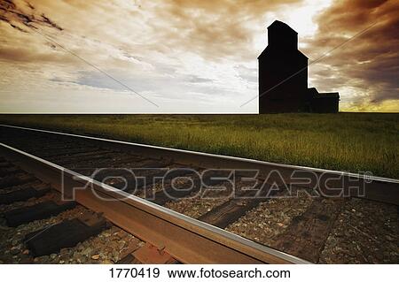 Train tracks with grain elevator View Large Photo Image Stock Photo - Train tracks with grain elevator. Fotosearch