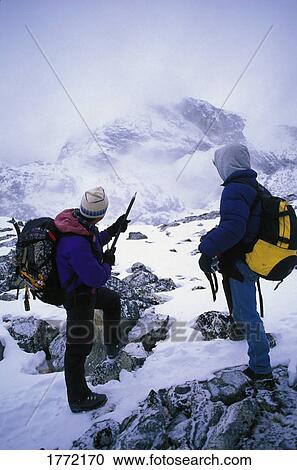 Two mountaineers surveying landscape View Large Photo Image Stock Image - Two mountaineers surveying landscape. Fotosearch