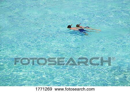 Two people snorkeling View Large Photo Image Stock Photo - Two people snorkeling. Fotosearch