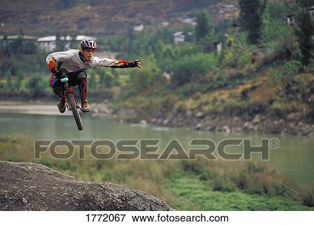 Unicyclist in the air View Large Photo Image Stock Photo - Unicyclist in the air. Fotosearch