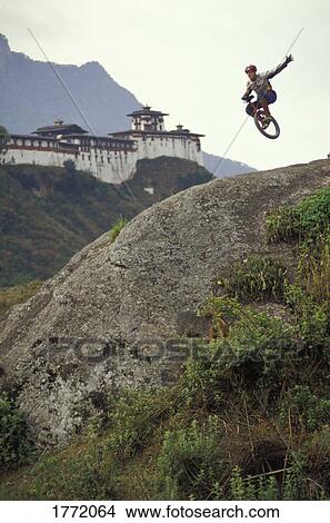 Unicyclist taking a jump down a hill View Large Photo Image Picture - Unicyclist taking a jump down a hill. Fotosearch