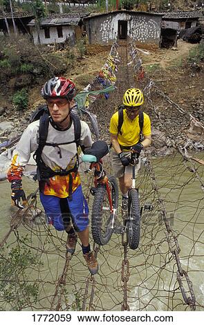 Stock Photo - Unicyclists crossing a river. Fotosearch
