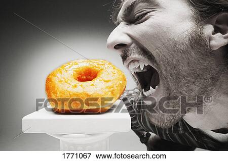 Werewolf eating a doughnut View Large Photo Image Stock Photo - Werewolf eating a doughnut. Fotosearch