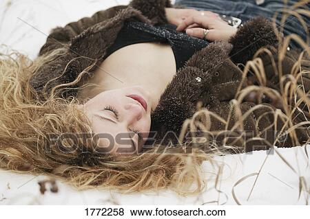 Woman laying on the sand View Large Photo Image Stock Photo - Woman laying on the sand. Fotosearch