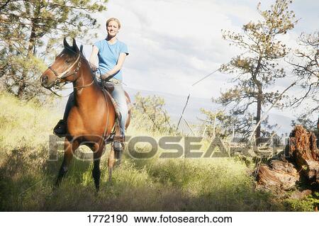 Stock Image - Woman on horse. Fotosearch