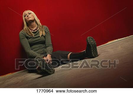 Picture - Woman waiting on floor. Fotosearch