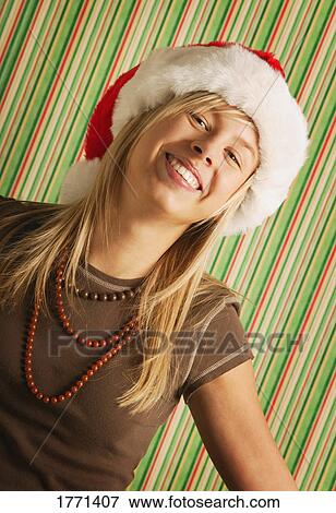 Woman wearing Santa hat View Large Photo Image Stock Photo - Woman wearing Santa hat. Fotosearch