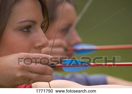 Stock Image - Women with bow and arrow. Fotosearch