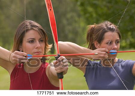 Stock Image - Women with bow and arrows. Fotosearch