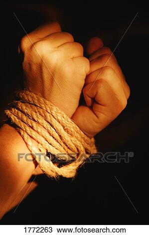 Stock Image - Wrists bound by rope. Fotosearch