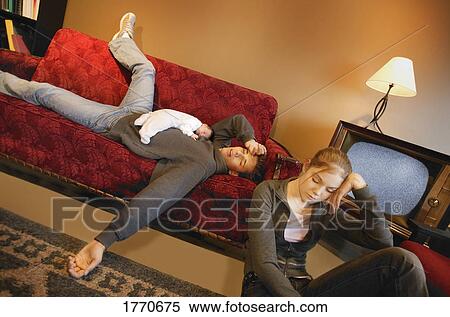 Young couple sleeping with new baby View Large Photo Image Stock Photography - Young couple sleeping with new baby. Fotosearch