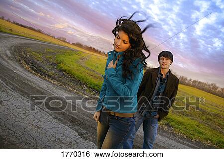 Young man and woman outdoors View Large Photo Image Stock Photograph - Young man and woman outdoors. Fotosearch