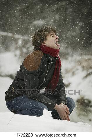 Young man tasting snow View Large Photo Image Stock Image - Young man tasting snow. Fotosearch