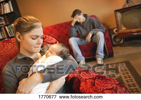 Stock Photo - Young stressed couple with new baby. Fotosearch