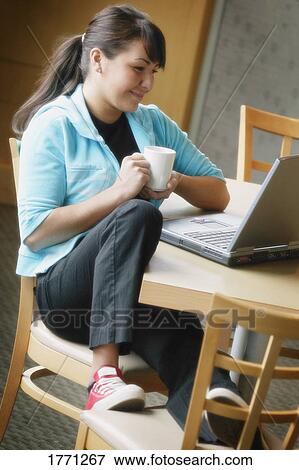 Stock Photo - Young woman with laptop. Fotosearch