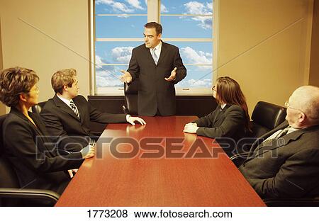Stock Photo - A business meeting. Fotosearch