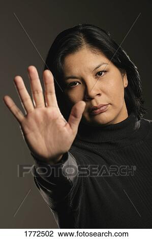Stock Image - Aboriginal woman gesturing STOP. Fotosearch