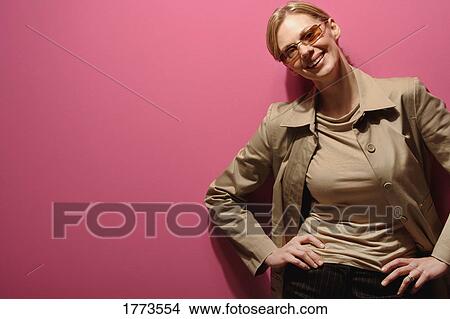 Picture - Attractive woman standing with hands on hips. Fotosearch