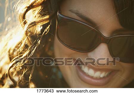 Attractive woman wearing trendy sunglasses View Large Photo Image Stock Image - Attractive woman wearing trendy sunglasses. Fotosearch