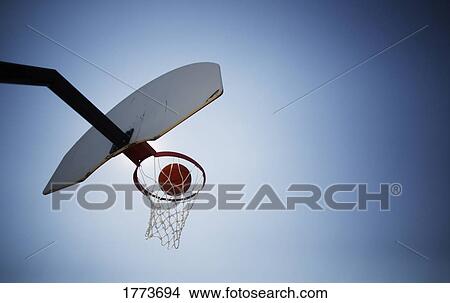 Basketball going through hoop View Large Photo Image Picture - Basketball going through hoop. Fotosearch