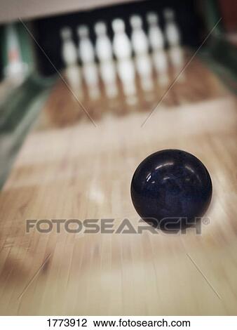 Stock Image - Bowling ball about to strike. Fotosearch