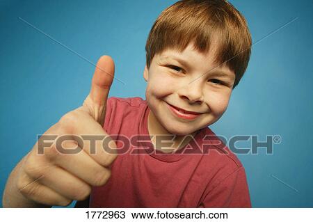 Stock Image - Boy giving the thumbs up sign. Fotosearch