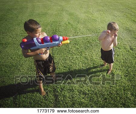 Stock Photo - Boy spraying another. Fotosearch