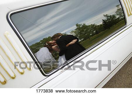 Bridal couple reflected in car window View Large Photo Image Stock Photo - Bridal couple reflected in car window. Fotosearch