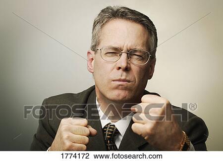 Businessman holding up fists View Large Photo Image Stock Image - Businessman holding up fists. Fotosearch