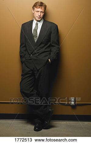 Businessman leaning on wall View Large Photo Image Stock Image - Businessman leaning on wall. Fotosearch