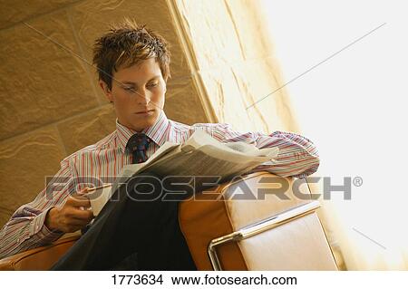 Businessman with cup of coffee and paper View Large Photo Image Picture - Businessman with cup of coffee and paper. Fotosearch