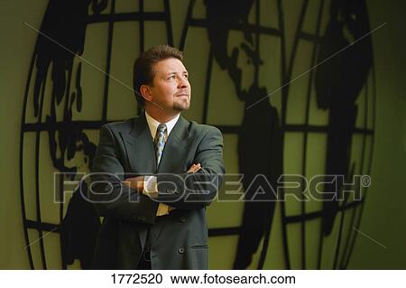 Businessman with image of world in background View Large Photo Image Stock Image - Businessman with image of world in background. Fotosearch
