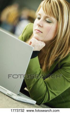 Stock Image - Businesswoman working at laptop. Fotosearch