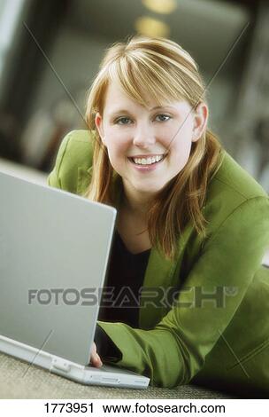 Stock Image - Businesswoman working on laptop. Fotosearch
