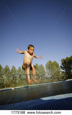 Child on the trampoline View Large Photo Image Stock Photo - Child on the trampoline. Fotosearch