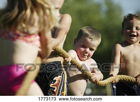 Children playing tug of war View Large Photo Image Stock Image - Children playing tug of war. Fotosearch