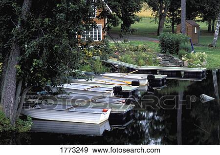Cottage with boats in water View Large Photo Image Stock Photo - Cottage with boats in water. Fotosearch