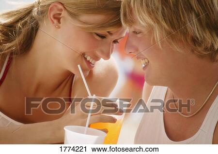 Stock Image - Couple drinking on hot day. Fotosearch