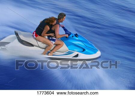 Couple on jet ski View Large Photo Image Picture - Couple on jet ski. Fotosearch
