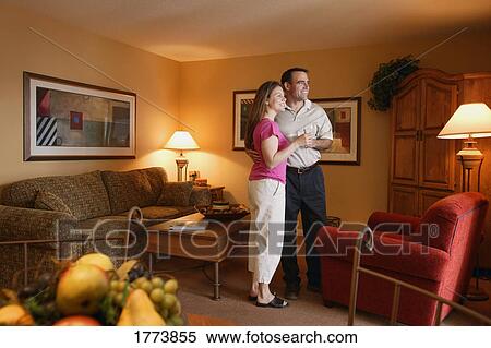 Stock Photography - Couple relaxing in room. Fotosearch
