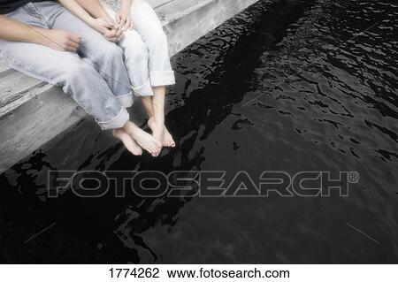 Couple sitting on dock View Large Photo Image Stock Image - Couple sitting on dock. Fotosearch