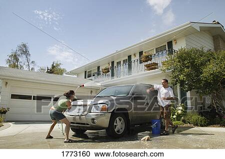 Couple washing the car View Large Photo Image Stock Image - Couple washing the car. Fotosearch