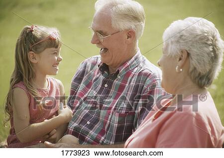 Doting grandparents with granddaughter View Large Photo Image Stock Image - Doting grandparents with granddaughter. Fotosearch