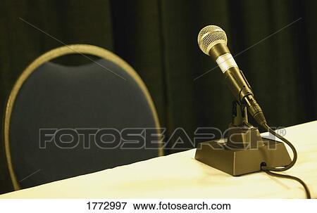 Empty chair and table with microphone View Large Photo Image Stock Photo - Empty chair and table with microphone. Fotosearch