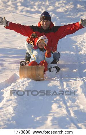 Father and daughter tobogganing View Large Photo Image Stock Image - Father and daughter tobogganing. Fotosearch