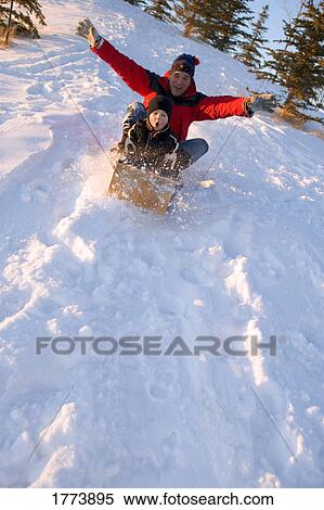 Father and son tobogganing View Large Photo Image Stock Photography - Father and son tobogganing. Fotosearch
